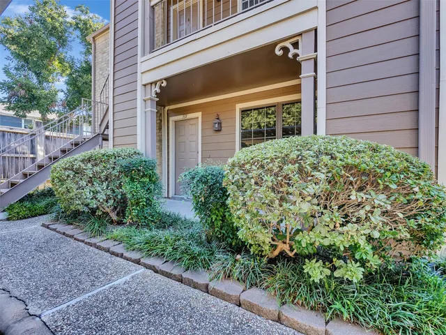a view of a house with potted plants