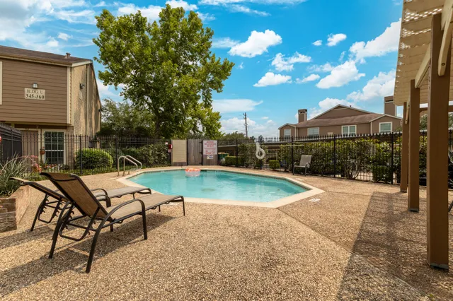 a view of a backyard with a patio and fire pit