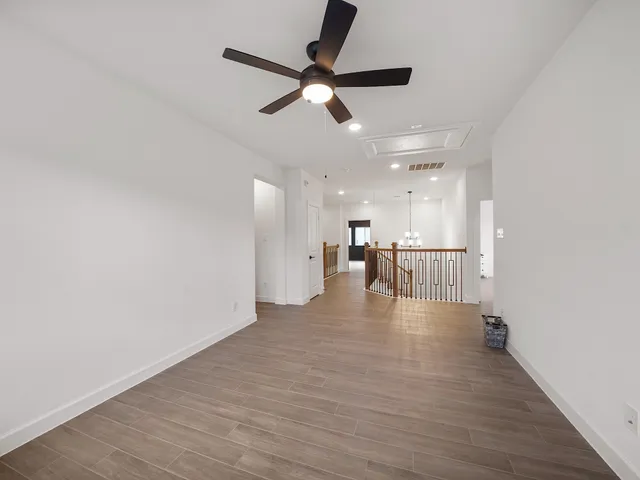 a view of a livingroom with a hardwood floor and a ceiling fan