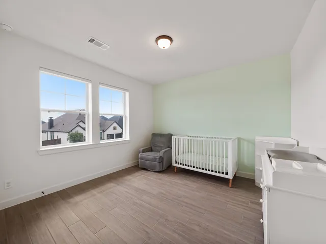 a view of room with baby crib and window
