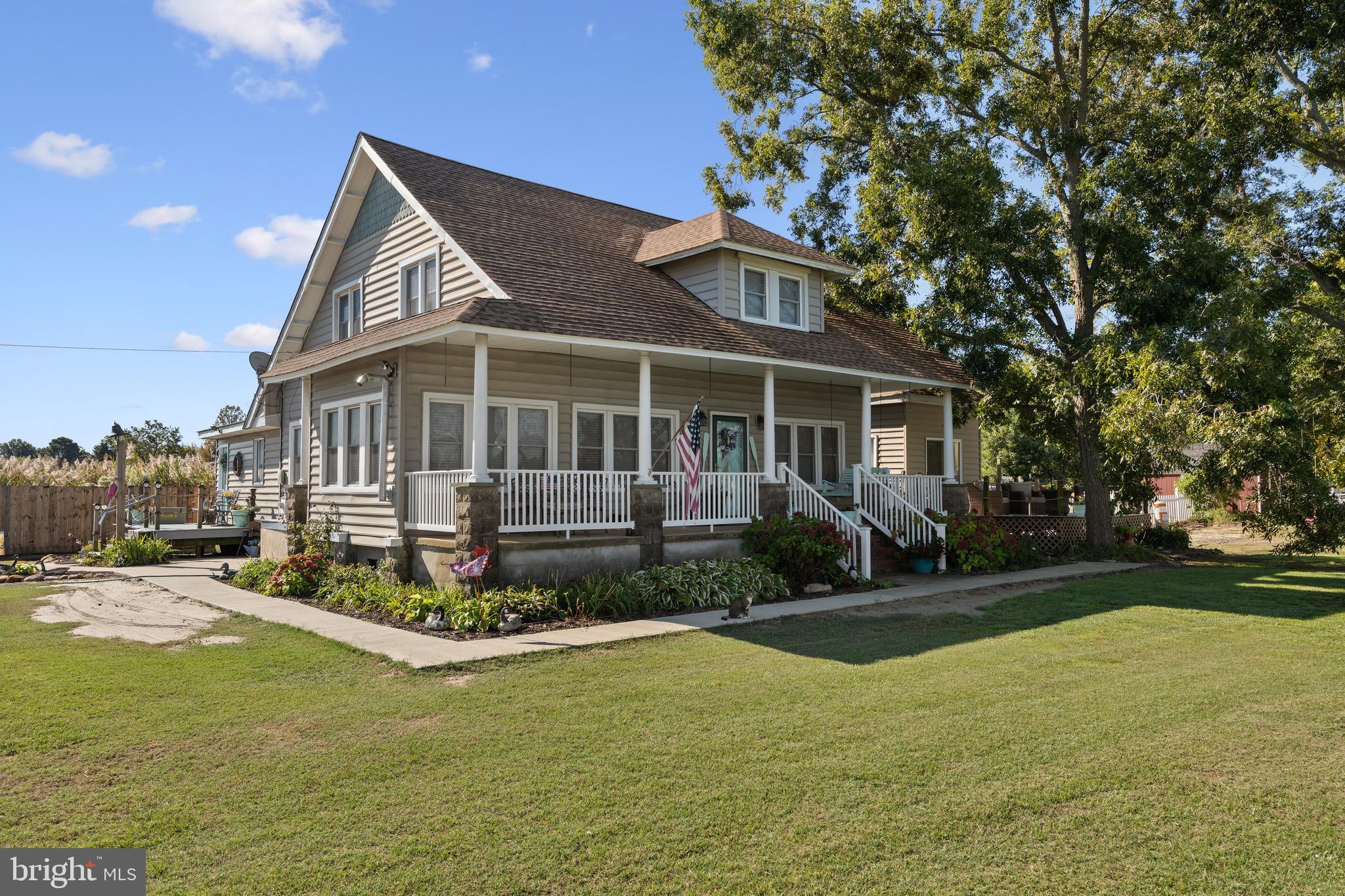 a front view of a house with a yard table and chairs