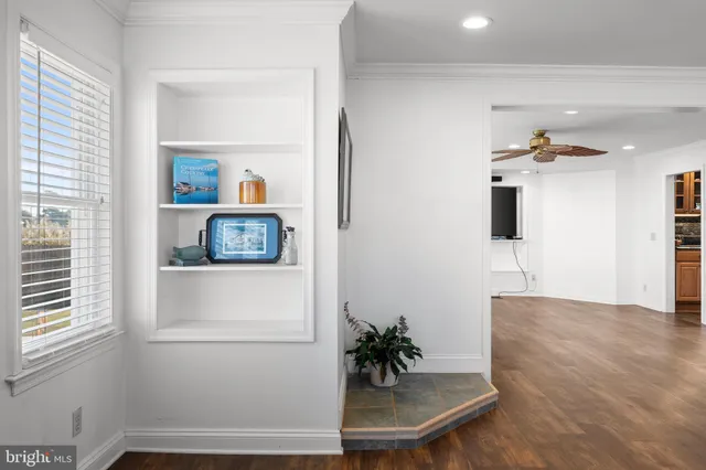 a view of empty room with a window and a flat screen tv
