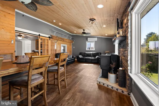 a living room with furniture fireplace and a large window