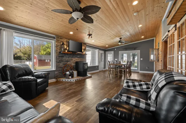 a dining room with furniture and wooden floor