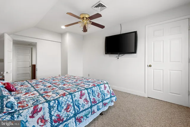 a view of a hallway with wooden floor and cabinet