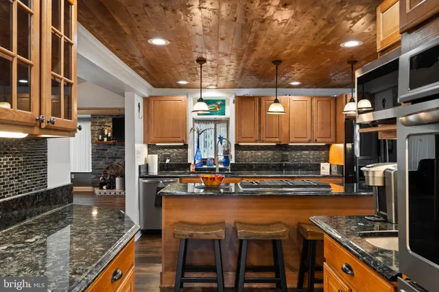 a kitchen with stainless steel appliances granite countertop a stove and a refrigerator