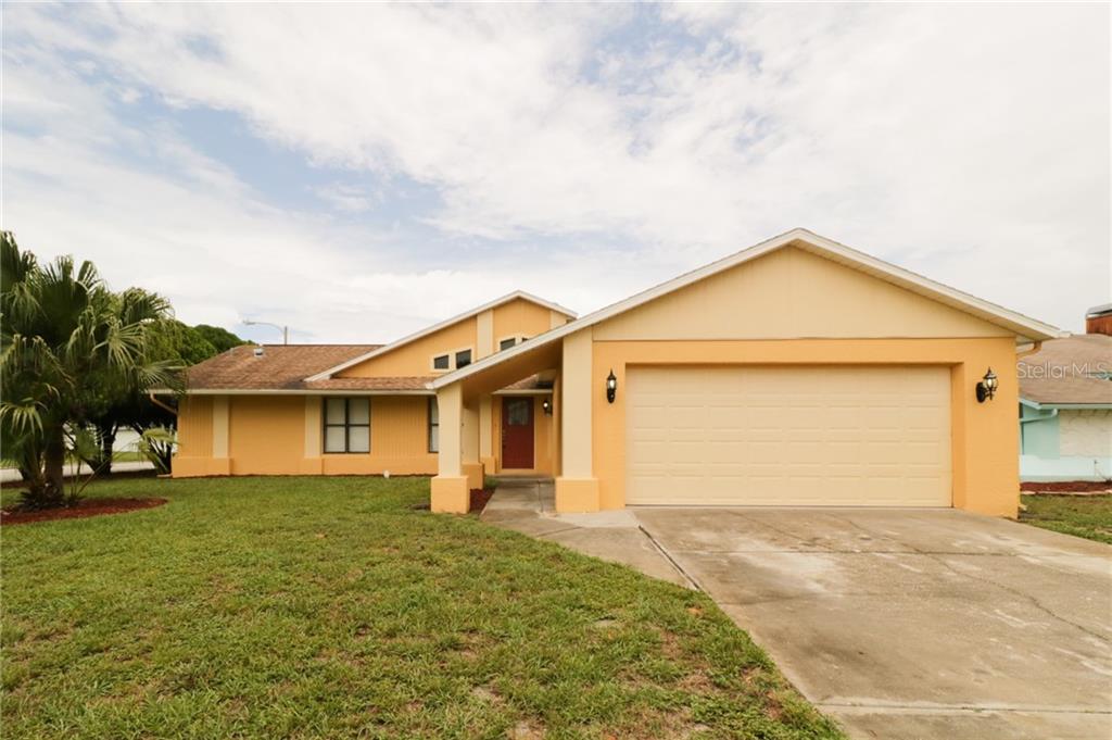 7809 Vienna Lane Port Richey, FL 34668 - Photo 1 of 1 a view of a house with a yard