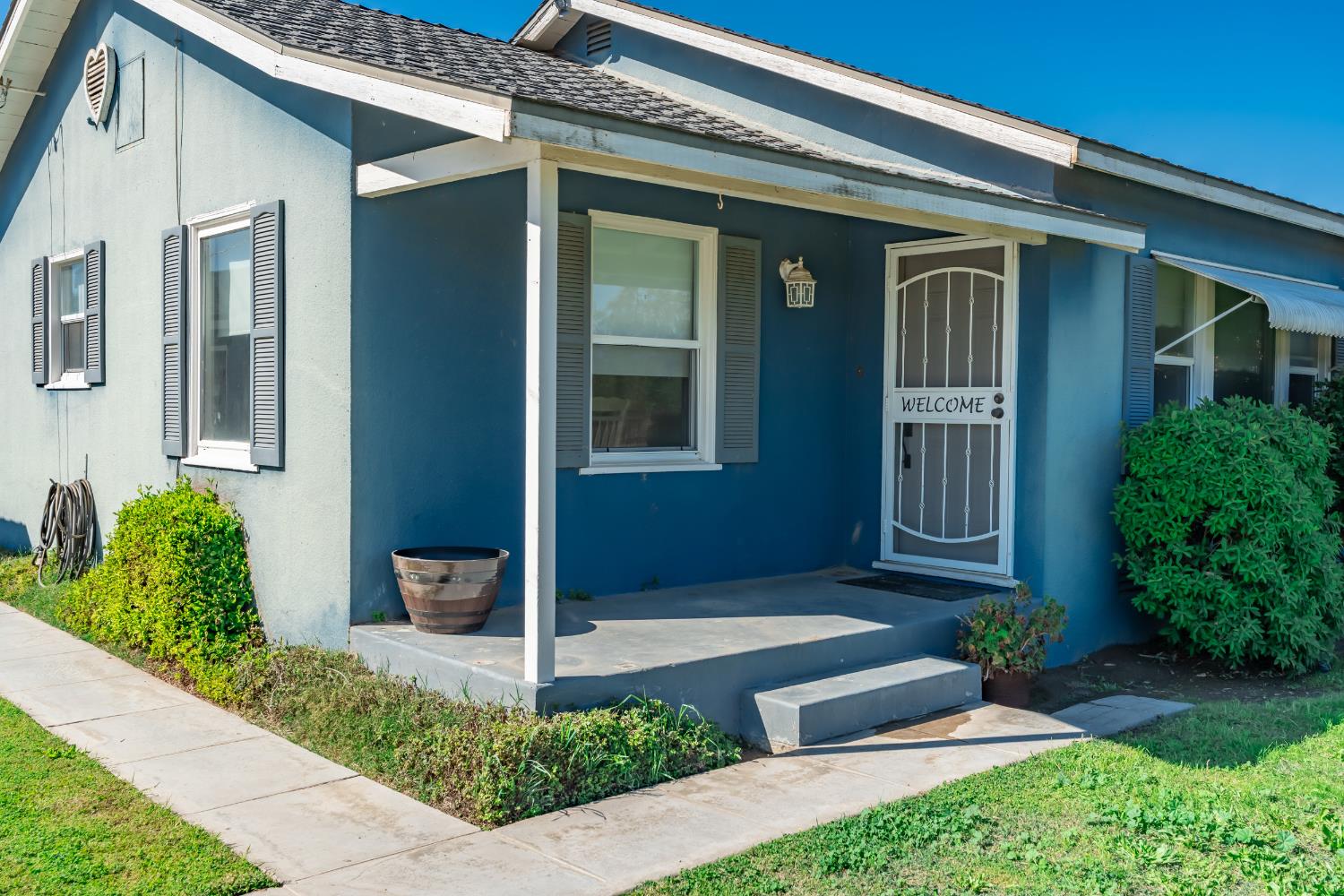 3058 7th Avenue Hanford, CA 93230 - Photo 1 of 38 a front view of a house with garden