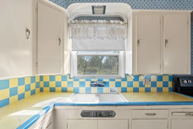 a view of kitchen with granite countertop window