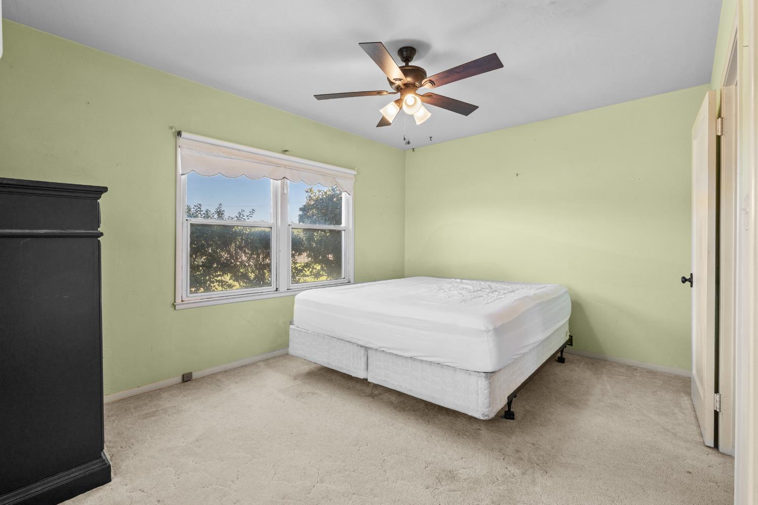 3058 7th Avenue Hanford, CA 93230 - Photo 13 of 38 a bedroom with a bed and a window