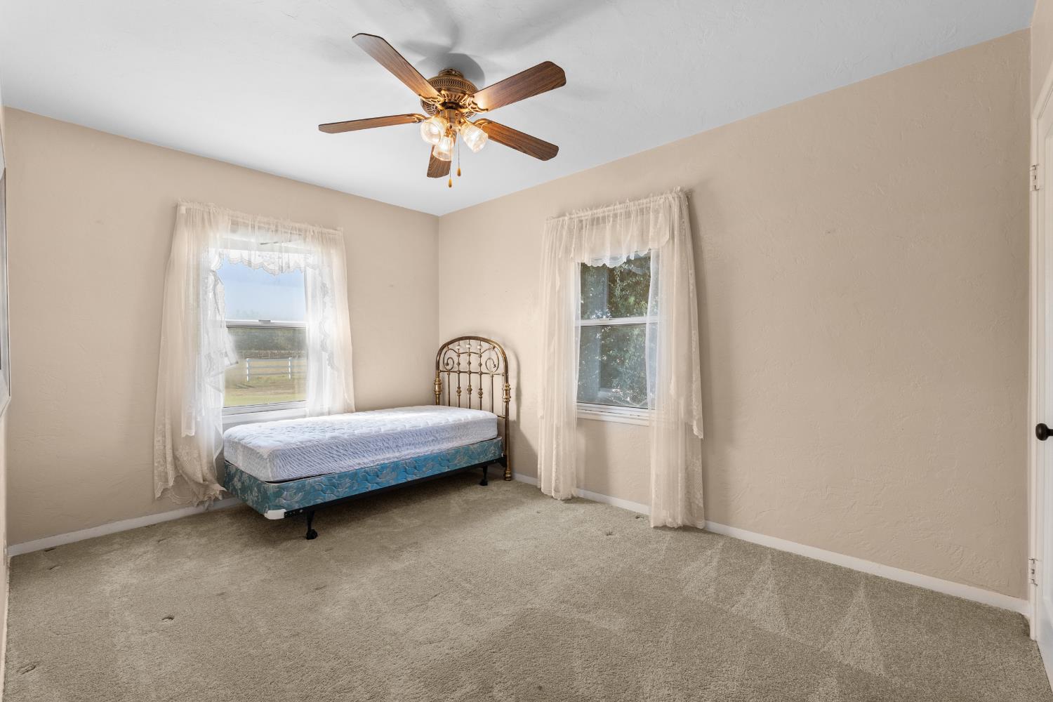 3058 7th Avenue Hanford, CA 93230 - Photo 14 of 38 a spacious bedroom with a bed and a large window