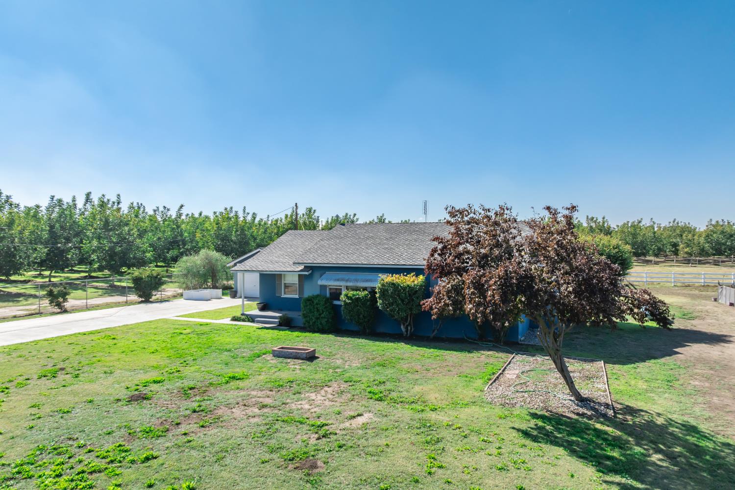 3058 7th Avenue Hanford, CA 93230 - Photo 19 of 38 a view of a house with garden and a yard