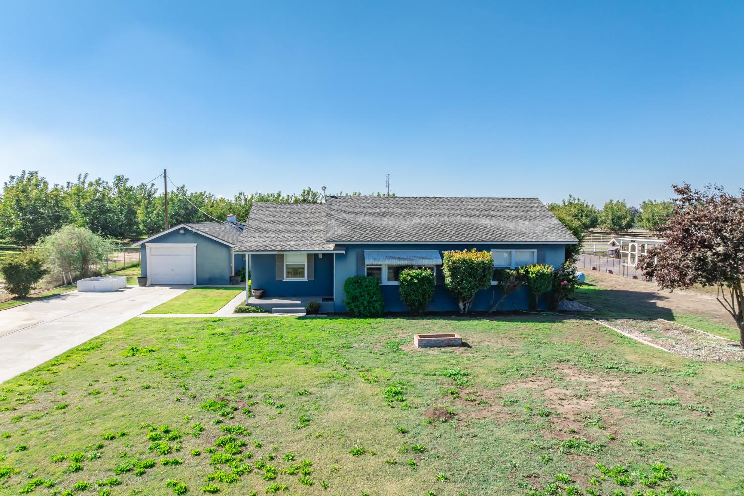 3058 7th Avenue Hanford, CA 93230 - Photo 20 of 38 a view of a house with a yard and potted plants