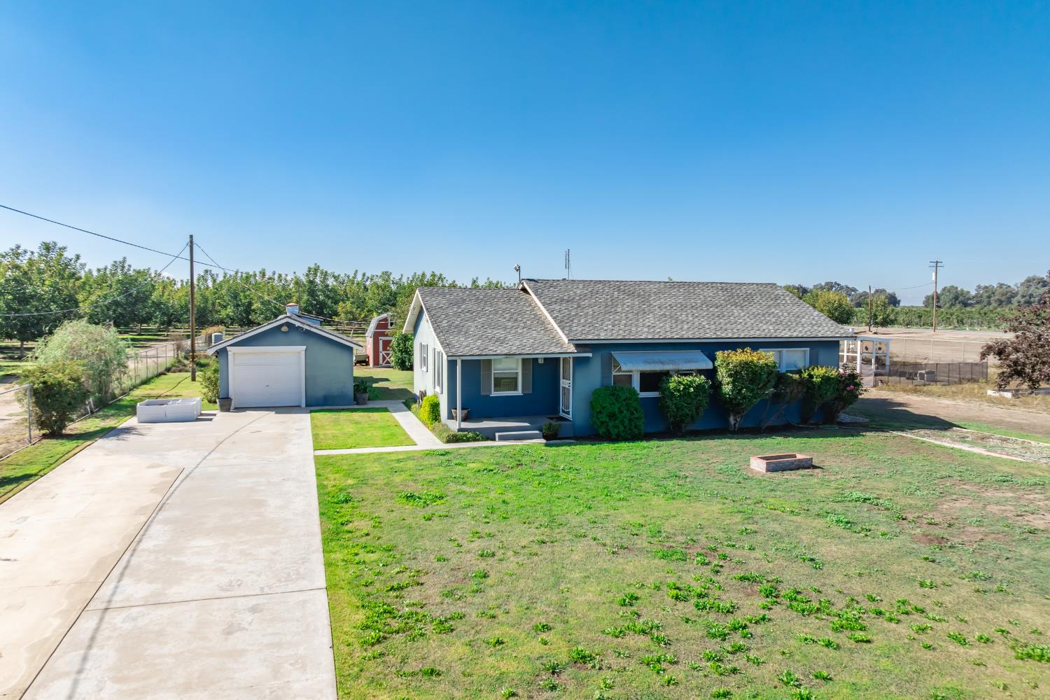 3058 7th Avenue Hanford, CA 93230 - Photo 21 of 38 a front view of a house with a yard and garage