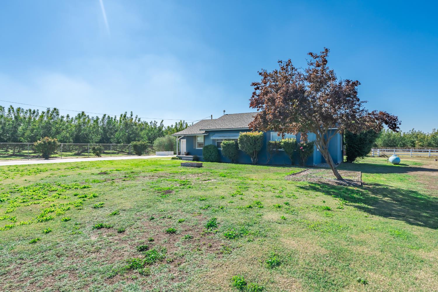 3058 7th Avenue Hanford, CA 93230 - Photo 22 of 38 a backyard of a house with lots of green space and fountain
