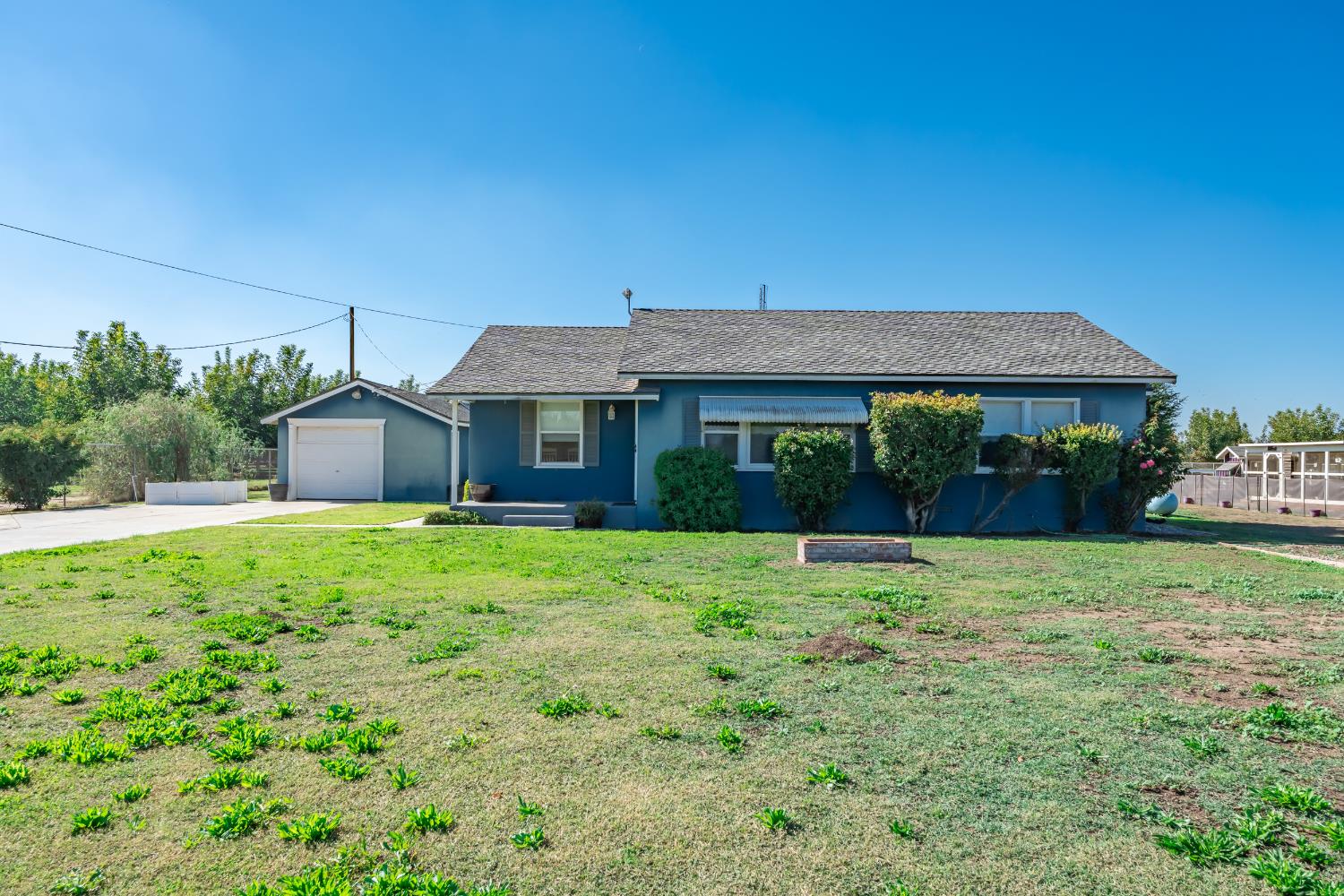 3058 7th Avenue Hanford, CA 93230 - Photo 3 of 38 a house view with a garden space
