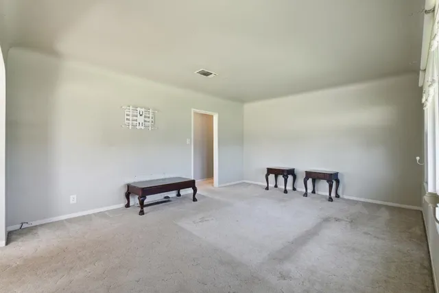 a view of a livingroom with a table and chairs