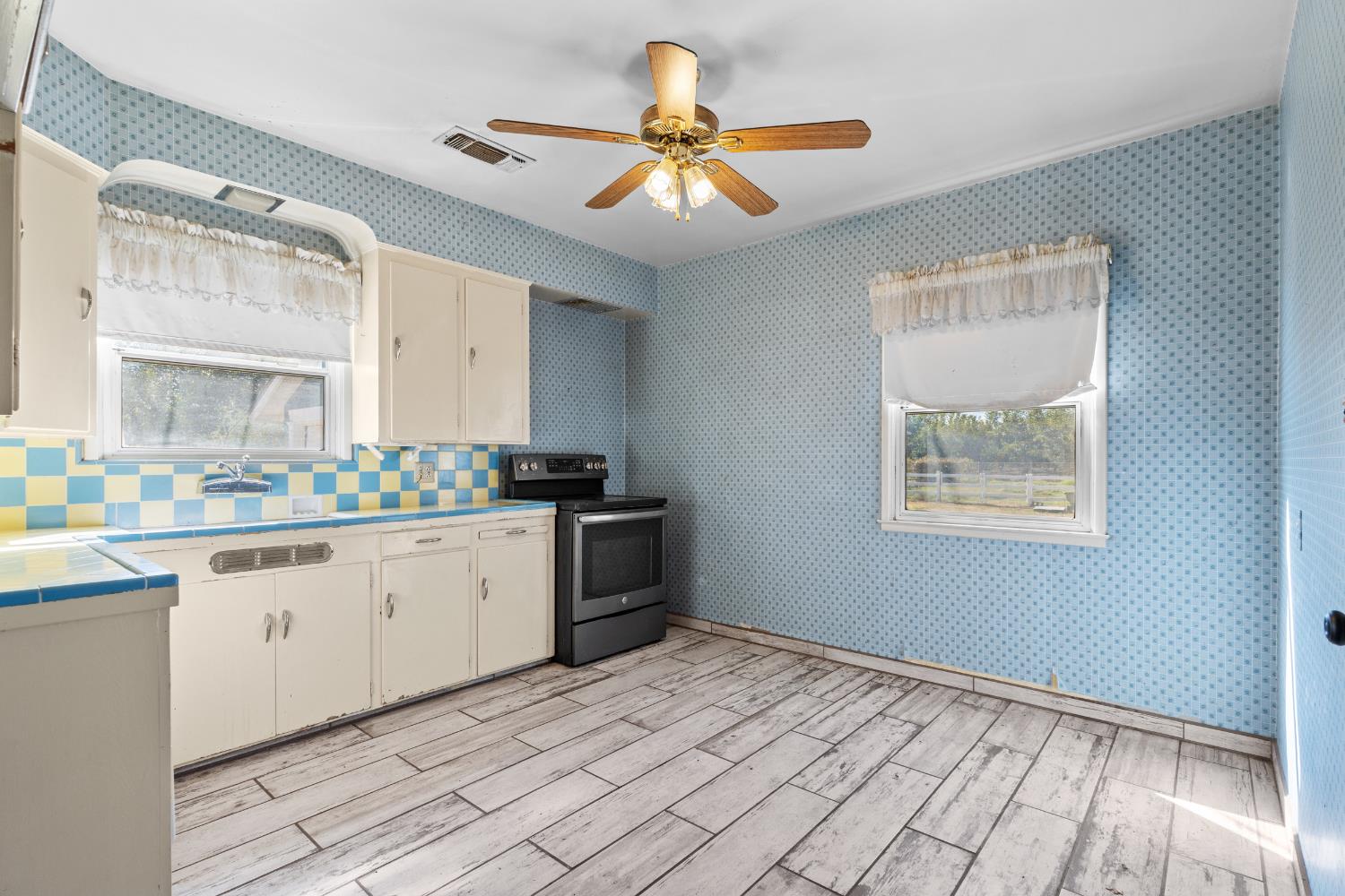 3058 7th Avenue Hanford, CA 93230 - Photo 8 of 38 a kitchen with a refrigerator and stove