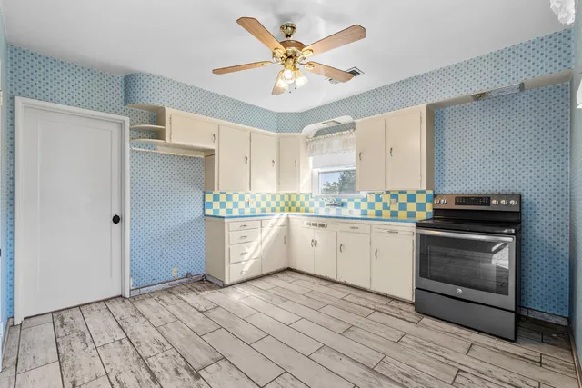 a kitchen with stainless steel appliances a stove a sink and a refrigerator
