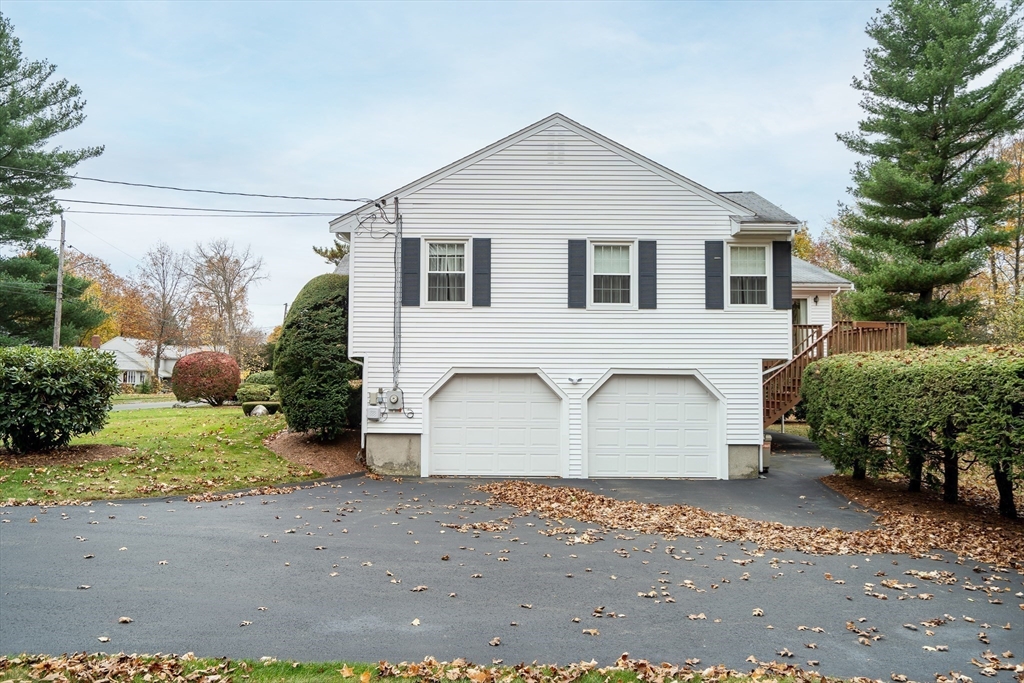19 Phinney Road Lexington, MA 02421 - Photo 41 of 42 a view of a white house with a yard and plants