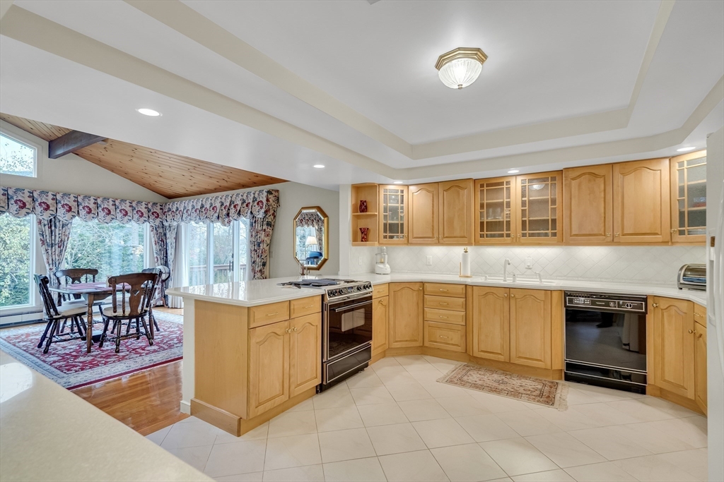 19 Phinney Road Lexington, MA 02421 - Photo 5 of 42 a kitchen with stainless steel appliances granite countertop a stove and a view of living room