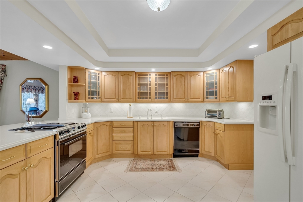 19 Phinney Road Lexington, MA 02421 - Photo 8 of 42 a kitchen with stainless steel appliances granite countertop a stove a sink and a microwave