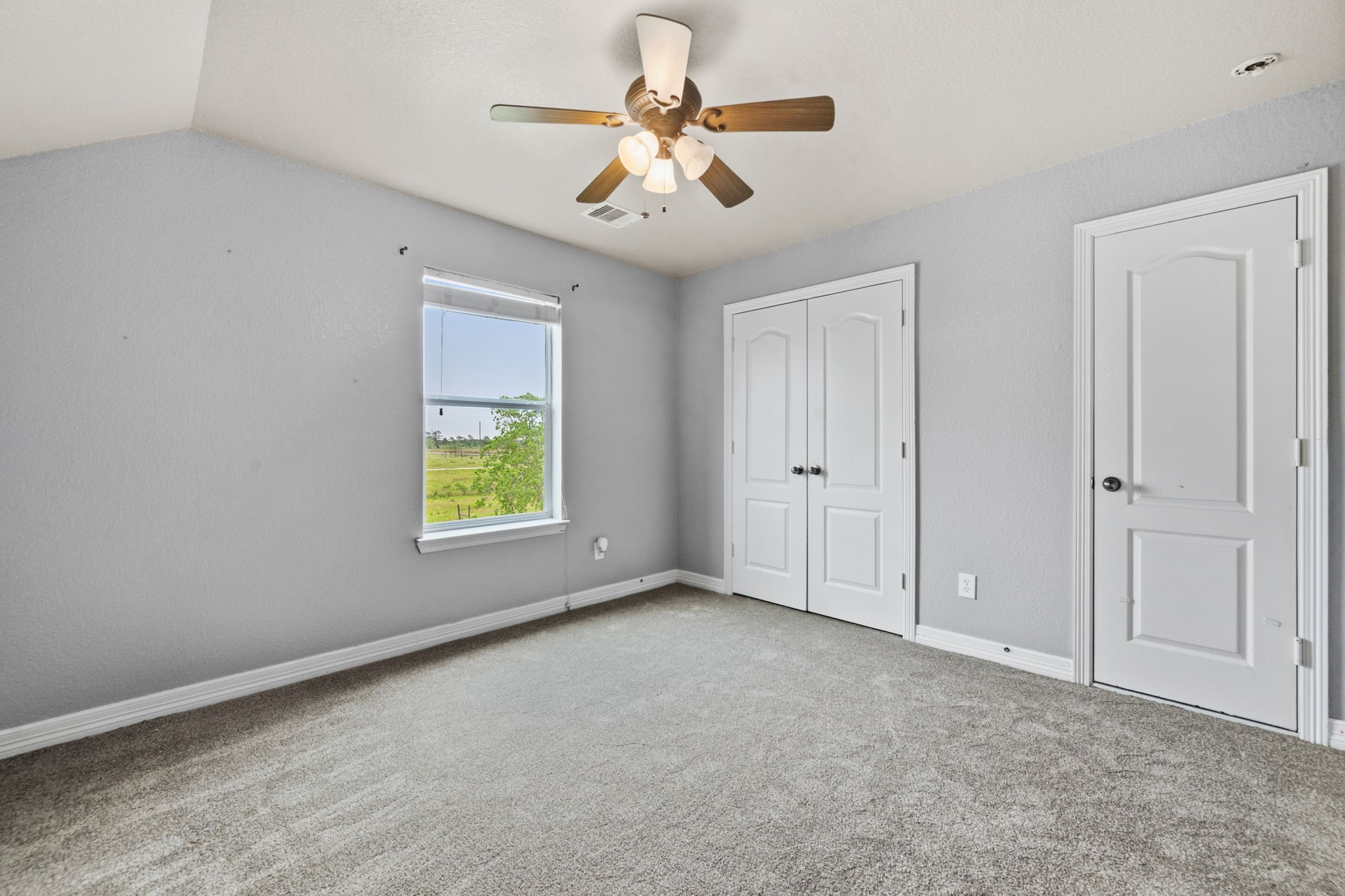 1405 Big Hill Road Winnie, TX 77665 - Photo 42 of 43 an empty room with windows and fan