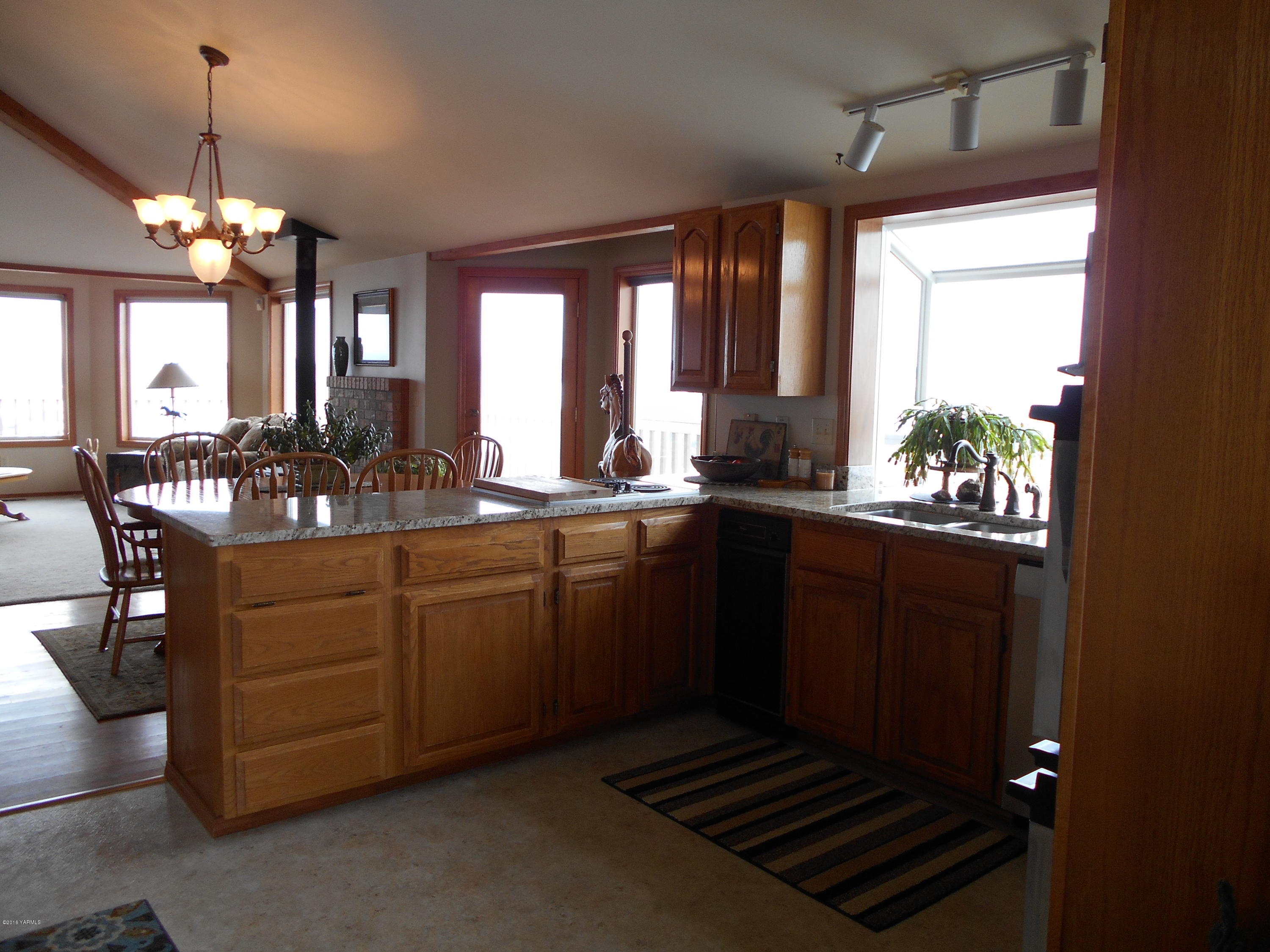 13910 Fisk Road Yakima, WA 98908 - Photo 18 of 48 a kitchen with sink cabinets and dining table