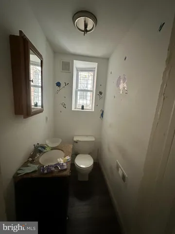 a bathroom with a sink toilet and mirror