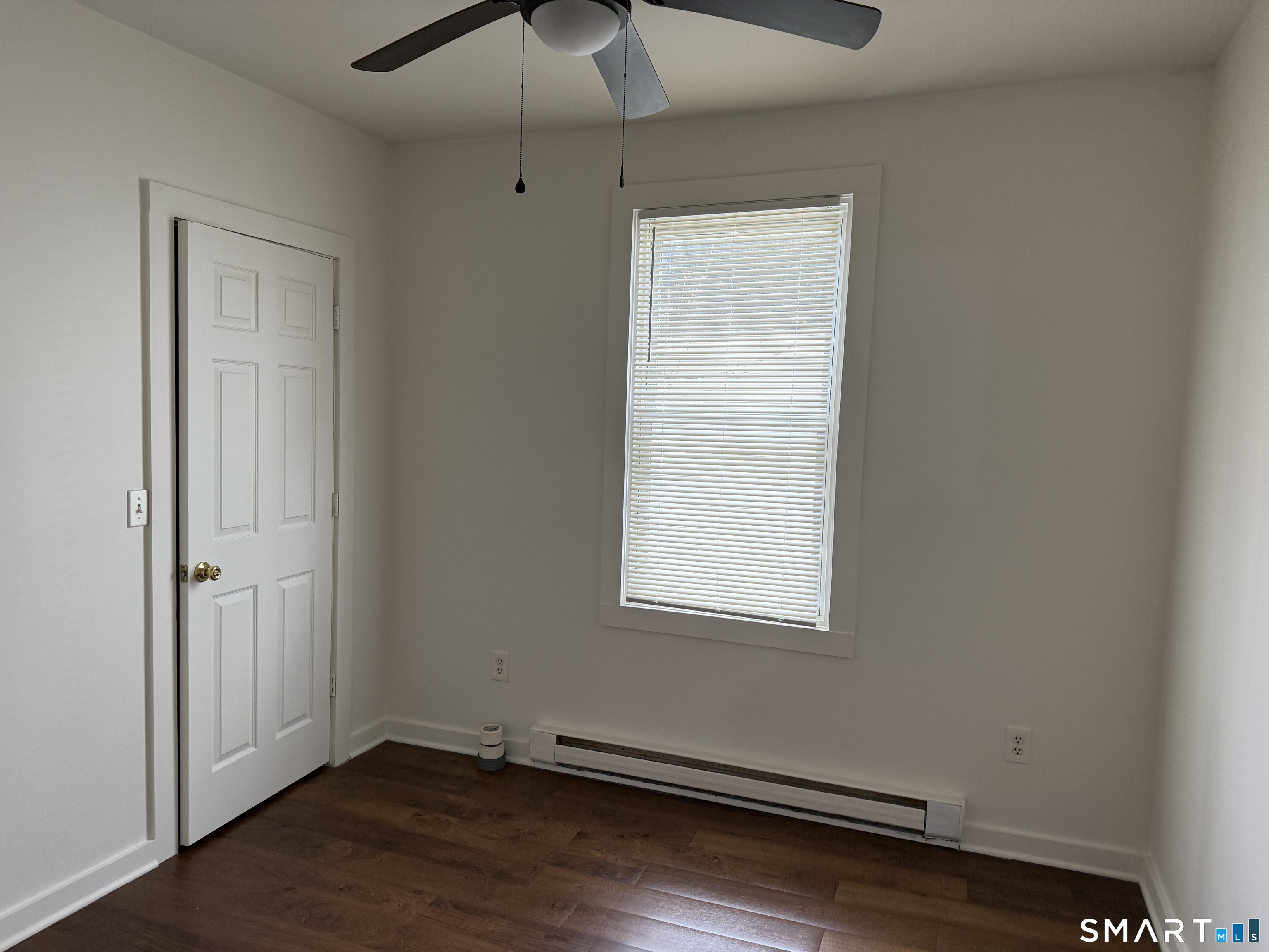 837 Bank Street, Unit 3 New London, CT 06320 - Photo 3 of 5 an empty room with wooden floor and windows