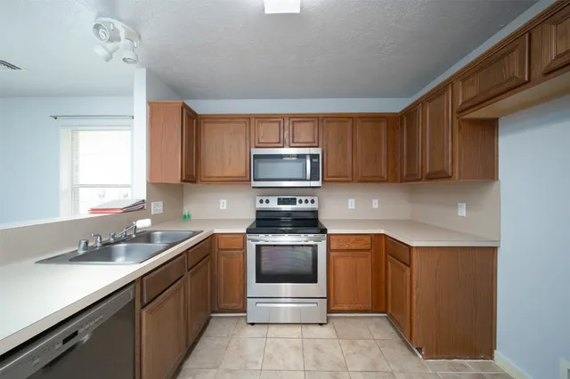 a kitchen with a sink and stainless steel appliances