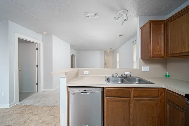a kitchen with stainless steel appliances granite countertop a sink and cabinets