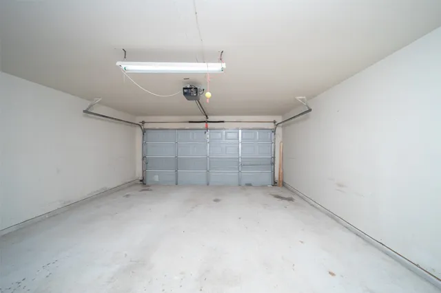 an empty room with a ceiling fan and window