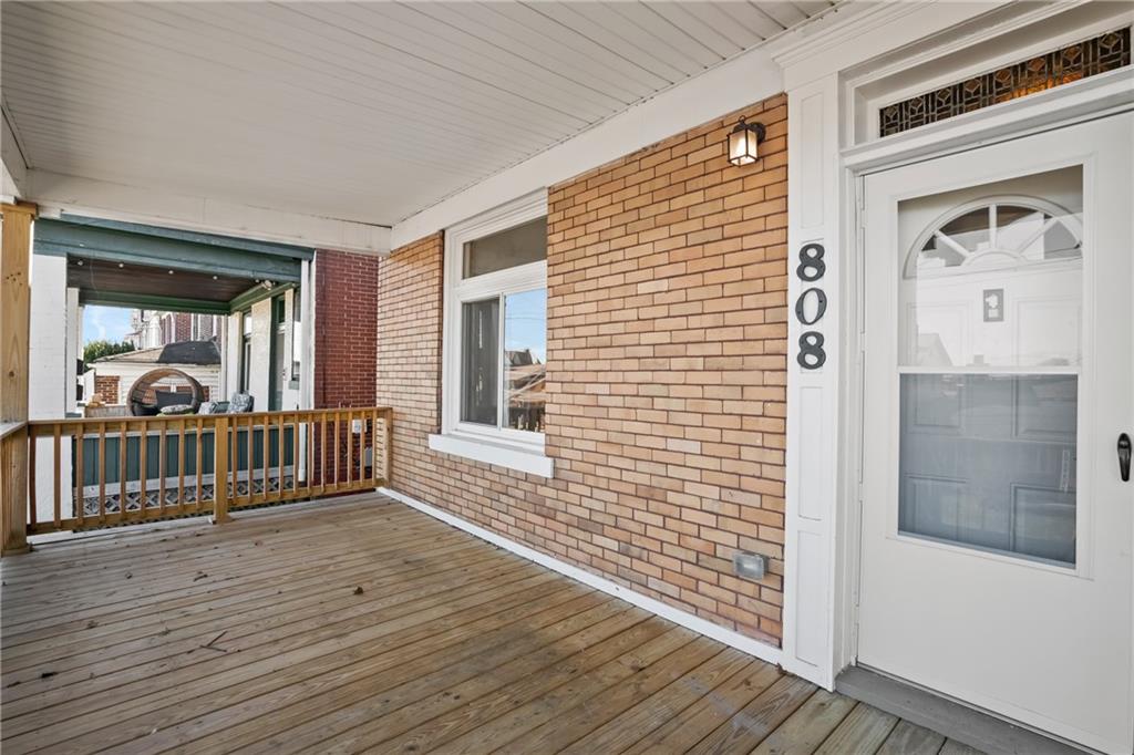 a view of a balcony with wooden floor