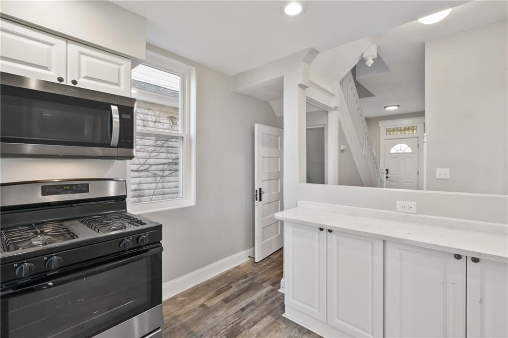 808 Bay Ridge Avenue Pittsburgh, PA 15226 - Photo 11 of 34 a kitchen with stainless steel appliances a stove and a microwave