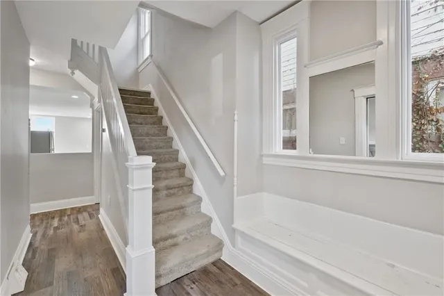 a view of staircase with white walls and windows