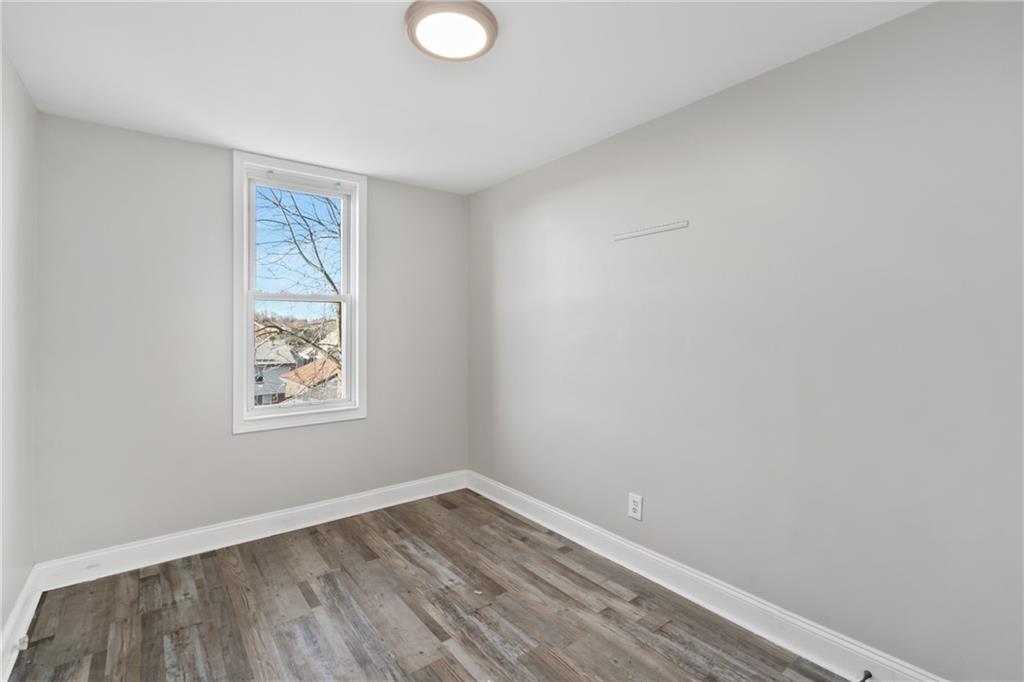 808 Bay Ridge Avenue Pittsburgh, PA 15226 - Photo 13 of 34 a view of an empty room with wooden floor and a window