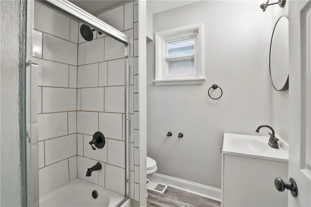 a bathroom with a shower and toilet