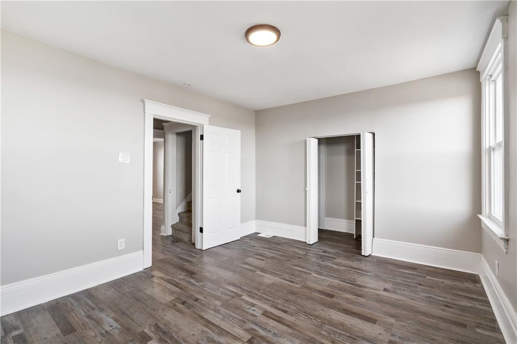 808 Bay Ridge Avenue Pittsburgh, PA 15226 - Photo 17 of 34 an empty room with wooden floor and windows