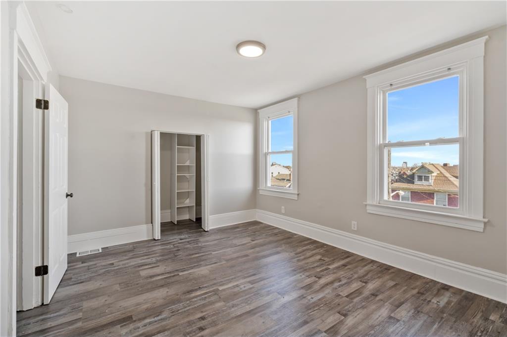 808 Bay Ridge Avenue Pittsburgh, PA 15226 - Photo 18 of 34 an empty room with wooden floor and windows