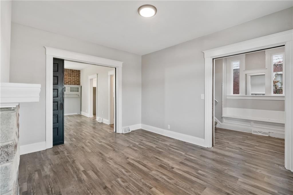 808 Bay Ridge Avenue Pittsburgh, PA 15226 - Photo 3 of 34 an empty room with wooden floor and windows