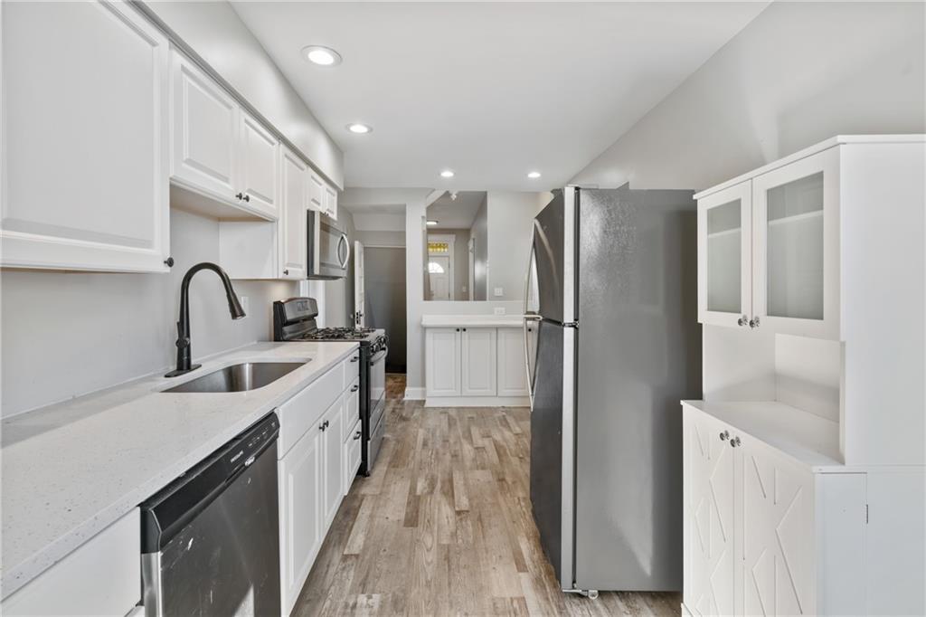 808 Bay Ridge Avenue Pittsburgh, PA 15226 - Photo 9 of 34 a kitchen with stainless steel appliances a sink stove and refrigerator