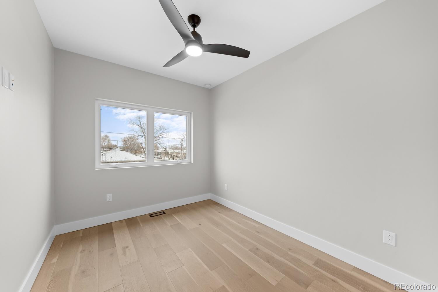 1306 Yates Street Denver, CO 80204 - Photo 23 of 29 an empty room with wooden floor and windows