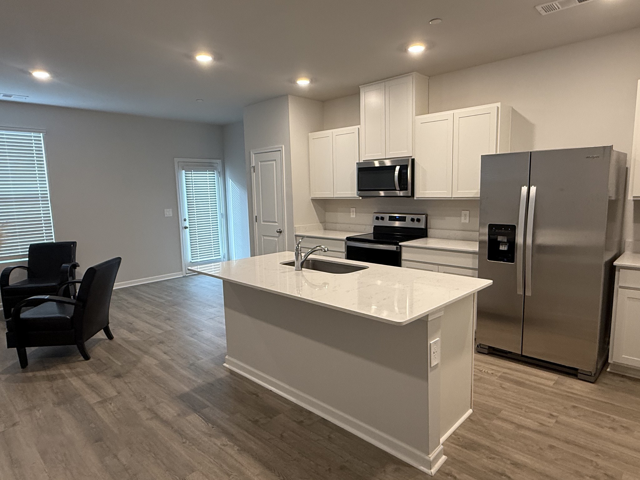 193 Mackenzie Way Lewisburg, TN 37091 - Photo 6 of 20 a kitchen with stainless steel appliances a refrigerator a stove a sink a dining table and chairs