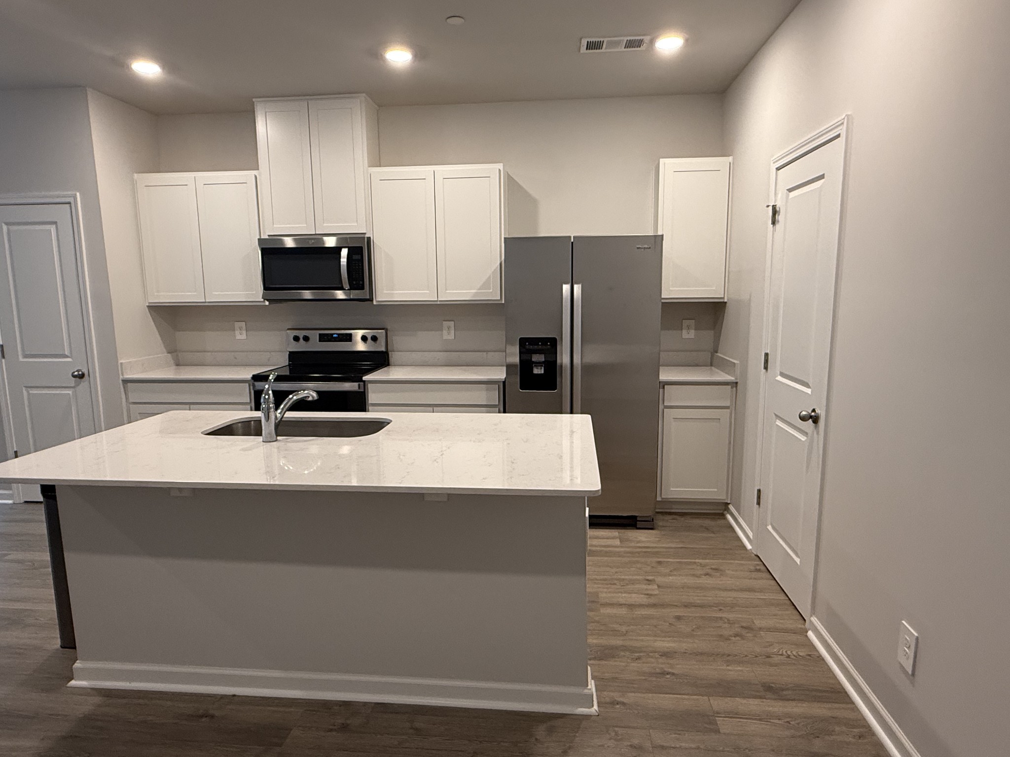 193 Mackenzie Way Lewisburg, TN 37091 - Photo 7 of 20 a kitchen with stainless steel appliances a refrigerator and a stove top oven