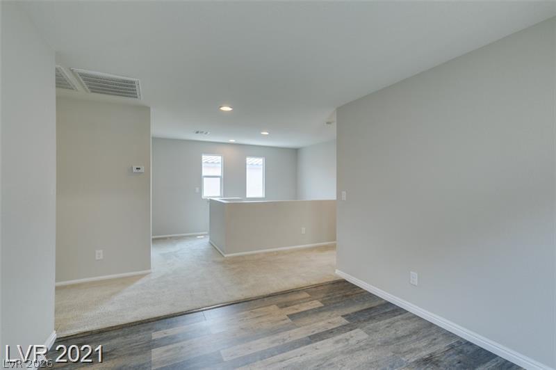 5475 Ordesa Valley Road Las Vegas, NV 89148 - Photo 18 of 35 A versatile upper-level bonus area offers adaptable space for relaxation or productivity.