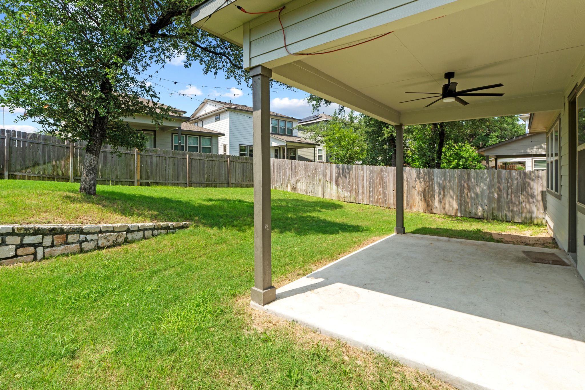 1101 Skeeter Cove Austin, TX 78748 - Photo 29 of 31 A spacious covered patio provides an ideal setting for outdoor entertaining, extending to a manicured lawn.