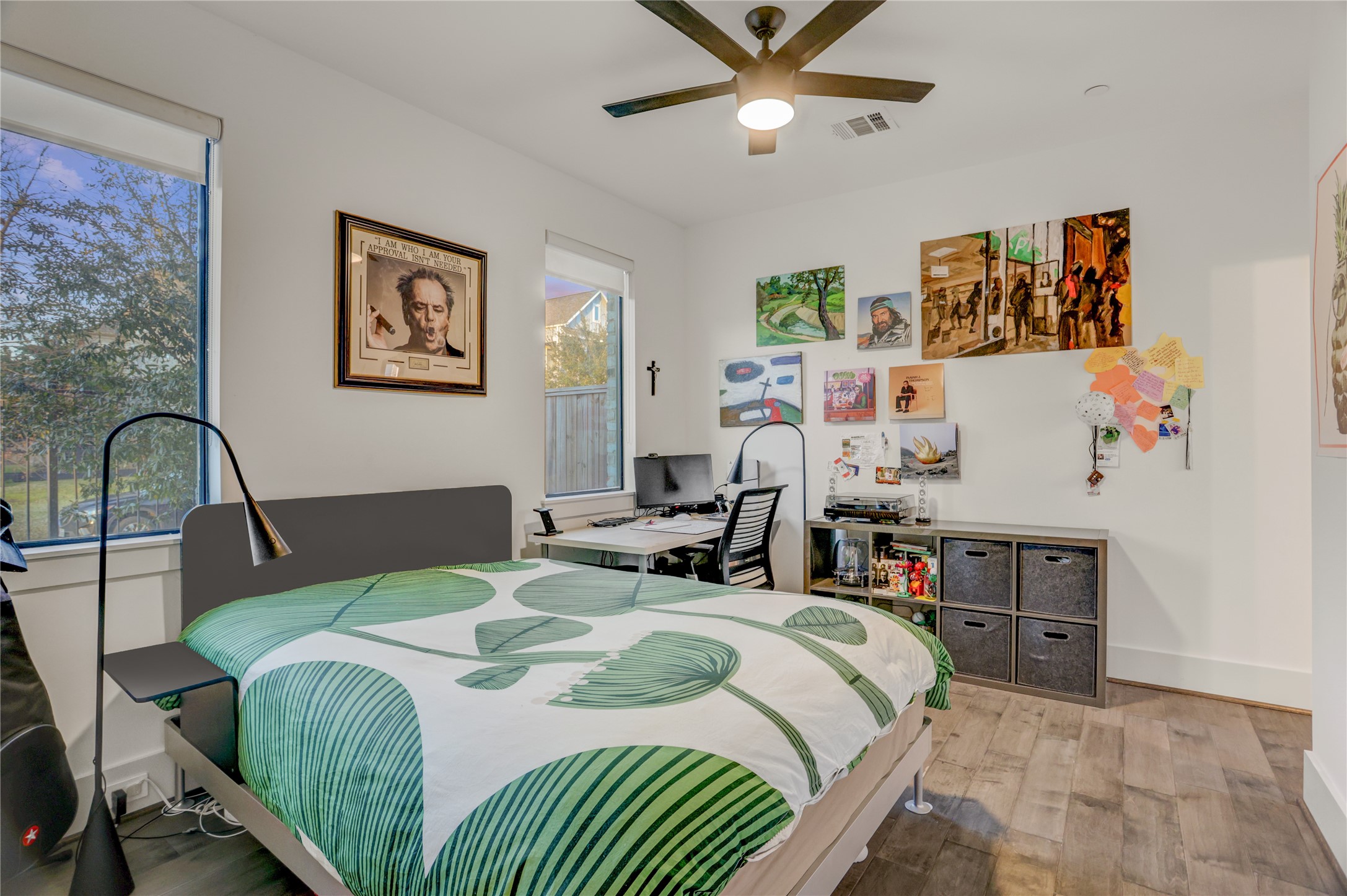 2435 Sheridan Street Houston, TX 77030 - Photo 17 of 25 Cozy secondary bedroom with ample natural light, modern ceiling fan, and versatile space for work or relaxation.