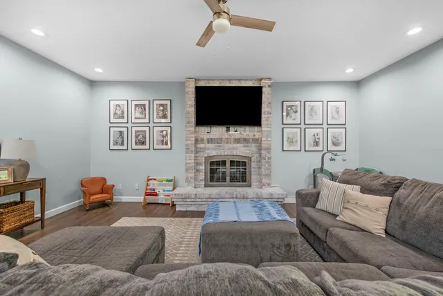 a living room with furniture fireplace and flat screen tv