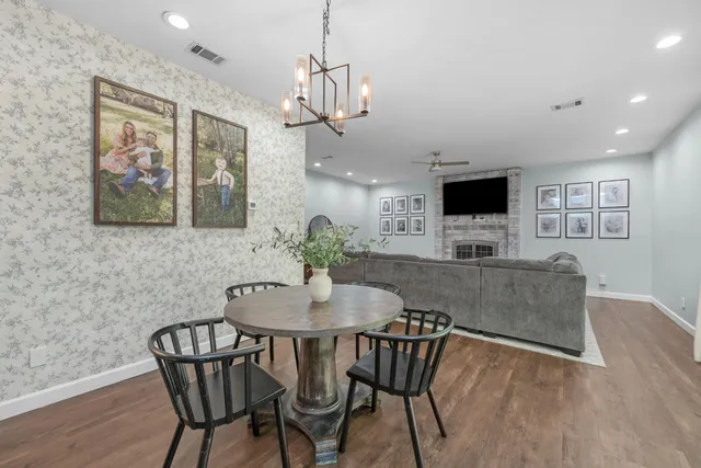 a view of a dining room with furniture wooden floor and a chandelier